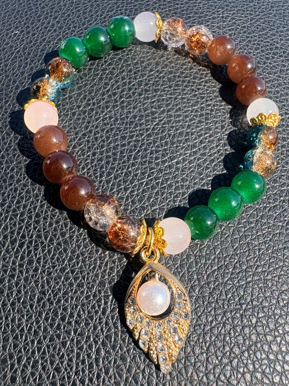 Green, brown, clear glass beaded bracelet with pearl charm and gold accents